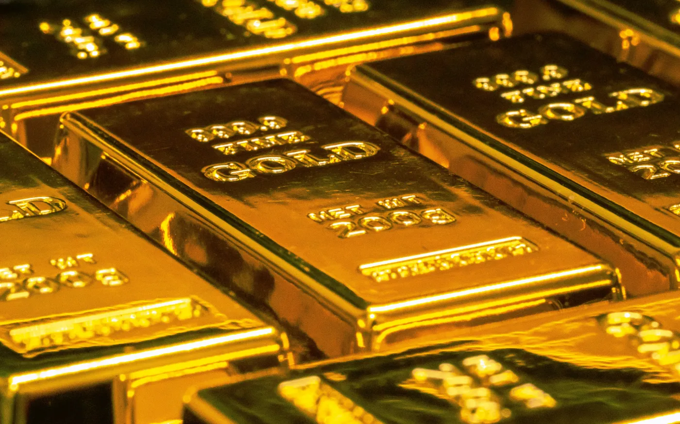 stacked gold bullion bars by Jingming Pan courtesy of Unsplash.