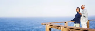 A couple on a dock looks at the ocean
