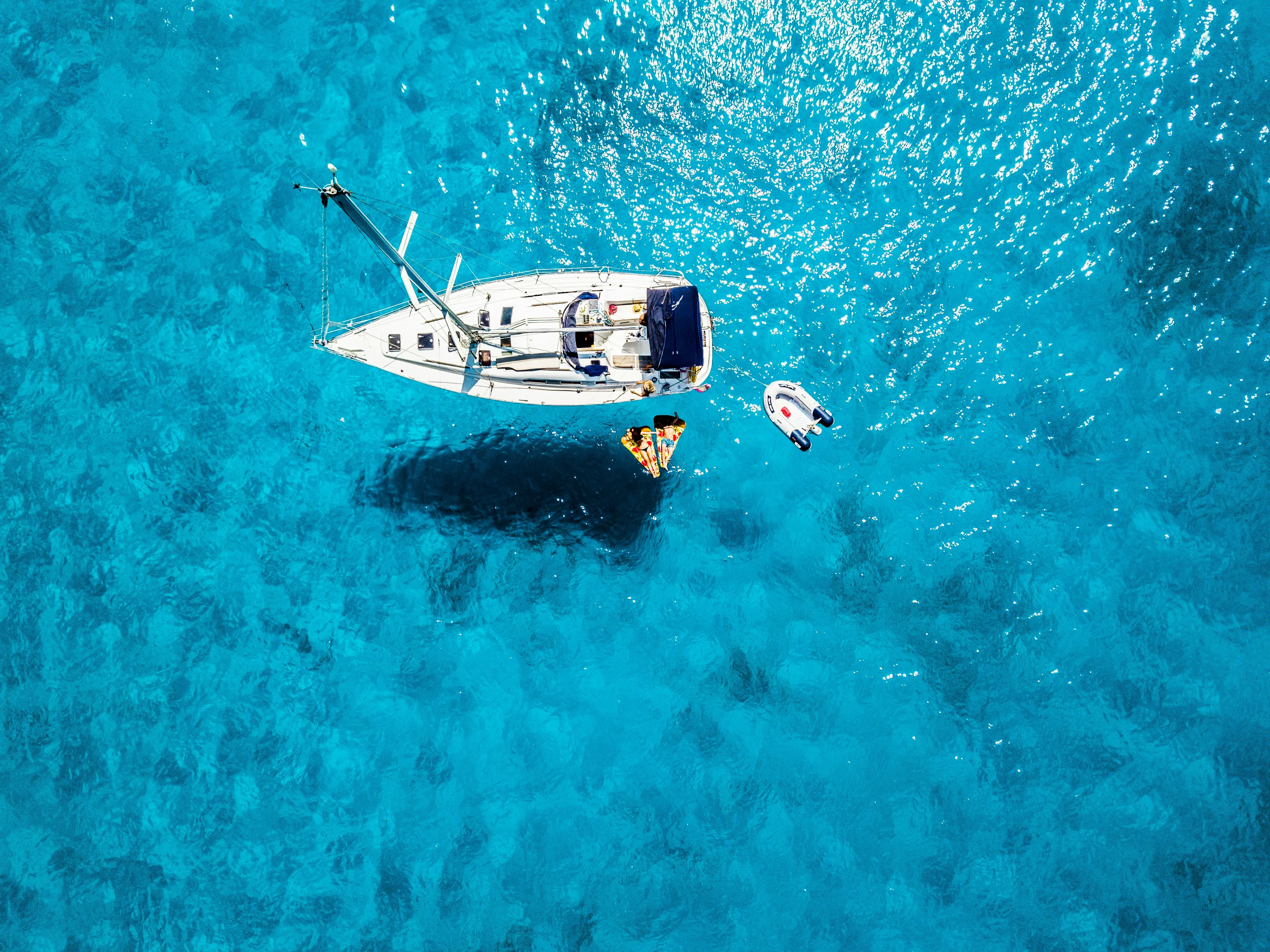 white yacht in middle of blue sea by Roberto H courtesy of Unsplash.