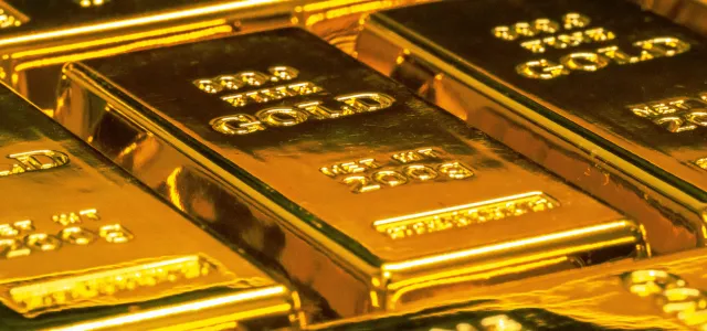 stacked gold bullion bars by Jingming Pan courtesy of Unsplash.